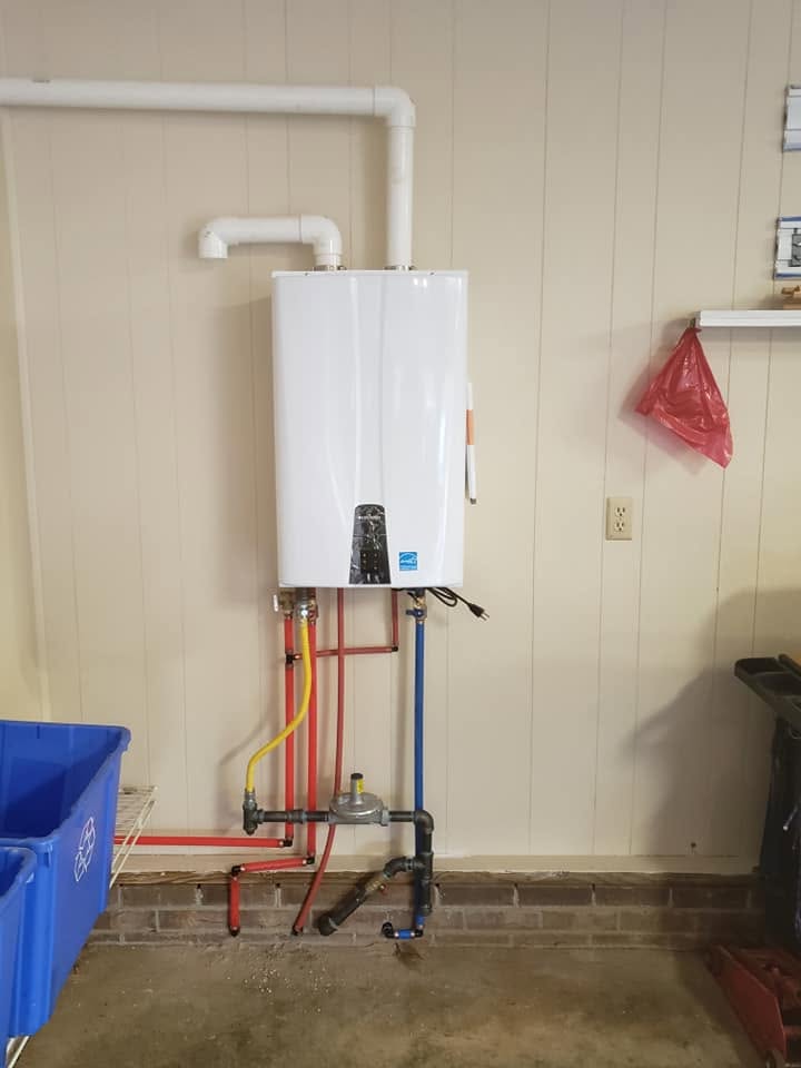 Wall-mounted tankless water heater with color-coded PEX and PVC venting